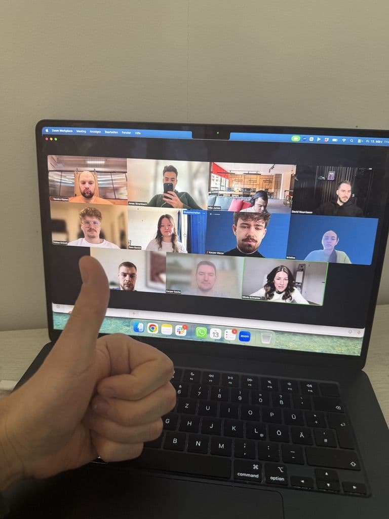 The whole team on a video call, thumbs up to the camera